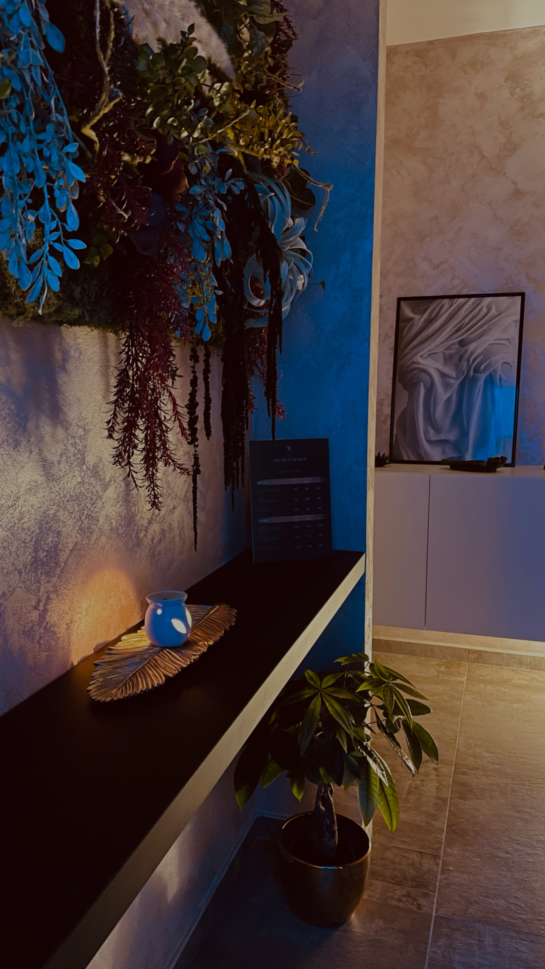 Corridoio del centro con parete blu notte e composizione di fiori secchi